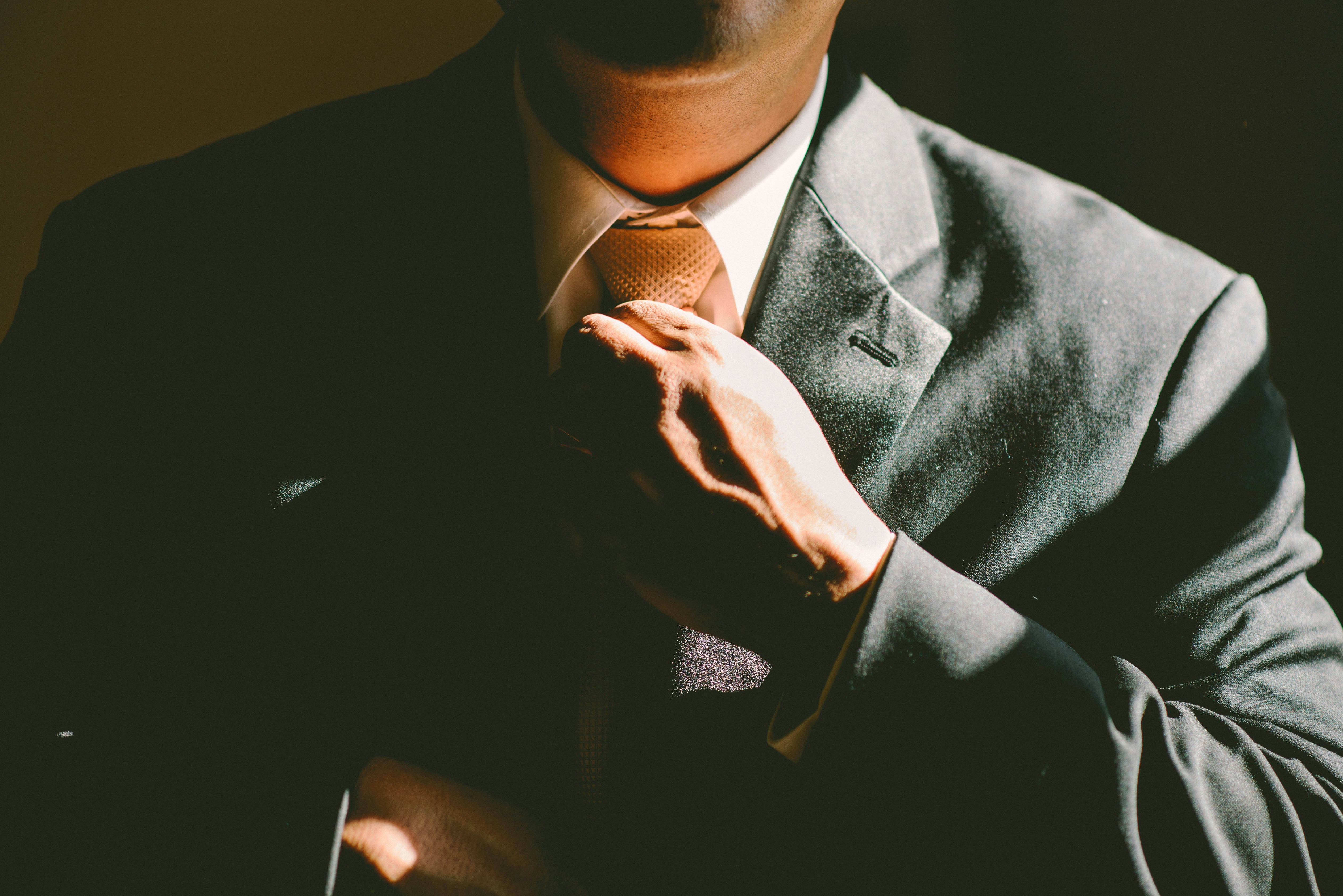 A professional adjusting his tie